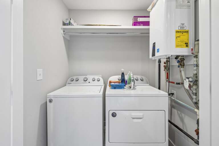 Full size washer and dryer tucked into a dedicated laundry nook for guest use - Overhead shelf provides space for detergents, supplies, and quick organization - Perfect for long stays, beach trips, or keeping fresh towels ready anytime
