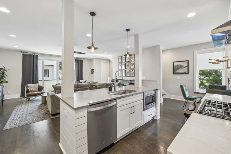 Modern kitchen with quartz countertops, stainless steel appliances, and bold backsplash - Spacious island with seating, ideal for breakfast, wine nights, or work time - Warm pendant lights and curated finishes elevate the entire culinary space