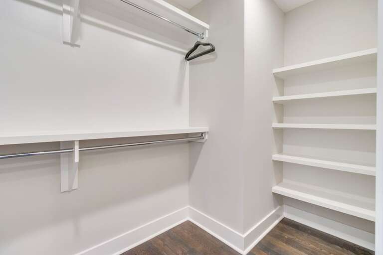 - Generous shelving and dual hanging rods provide extra space for all your belongings - Clean white finishes and wood flooring create a crisp, organized storage area - Ideal for longer stays, offering plenty of room for suitcases, shoes, and wardrobe