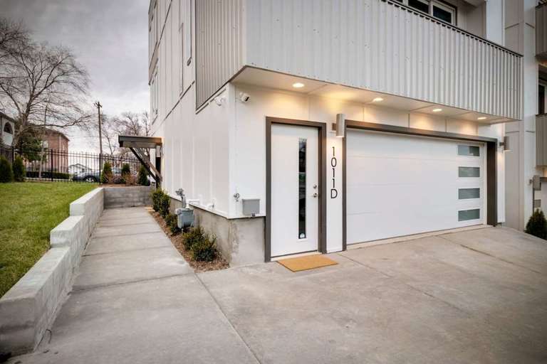 The garage can accommodate two full-size cars and has an entrance for guests