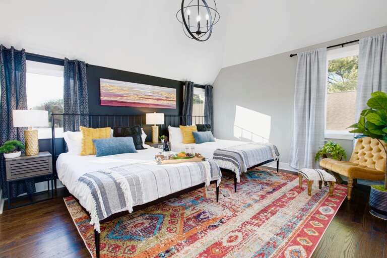 - Wake up in style with bold patterns, cozy throws, &amp; a sun filled retreat - Two comfy beds, layered textures, &amp; a rich vintage rug set the tone for relaxation - Perfect for friends, or couples, this colorful space feels like a getaway within a ge