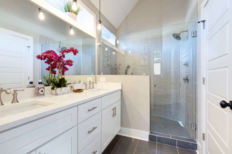 - Step into spa vibes with a sleek walk in shower and bright, airy design - Double sinks, fresh florals, and glowing vanity lights add stylish function - From morning refresh to evening wind down, this space feels like a treat
