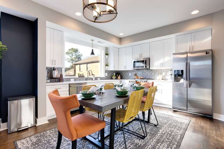 - Whip up your favorites in this bright kitchen with stainless steel shine - Gather round a fun mix of yellow and orange chairs that pop with personality - Big windows, clean lines, and everything you need to cook or kick back  