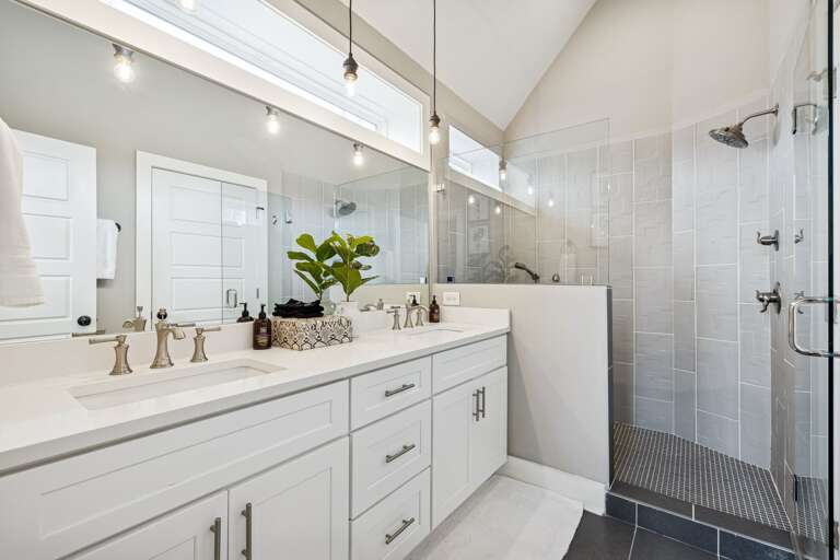 - Step into spa vibes with a sleek walk in shower and bright, airy design - Double sinks, fresh florals, and glowing vanity lights add stylish function - From morning refresh to evening wind down, this space feels like a treat