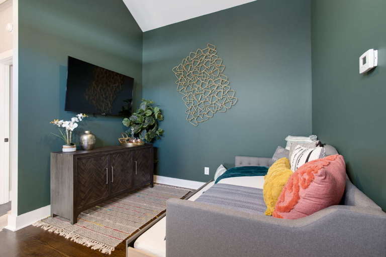 Upstairs flex space features a day bed and pull out twin size trundle bed