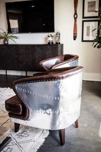 Rugged leather chairs with metal backs make for all the comforts of home