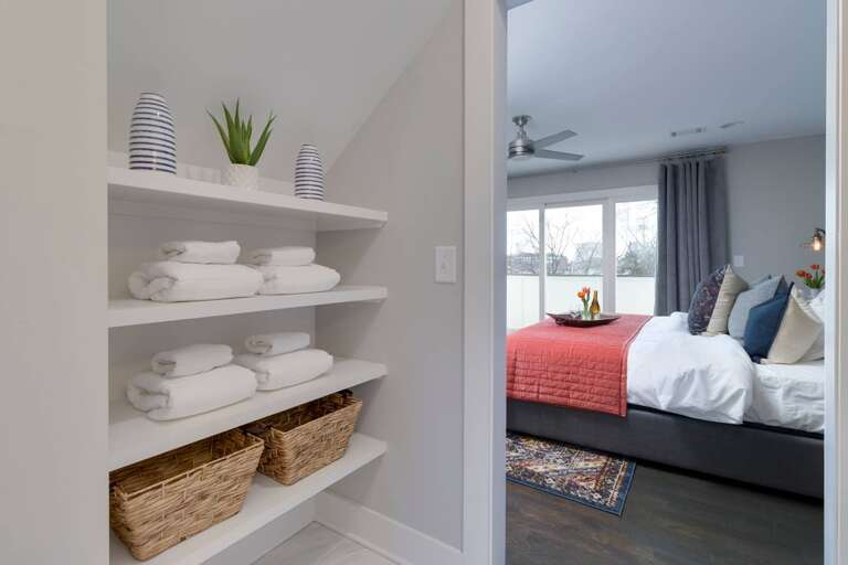 - Built in shelves with rolled towels, woven baskets, and stylish decor for guest ease - Located just outside the bedroom for quick access to extra linens and essentials - Organized and clean, designed with convenience and comfort in mind for every stay