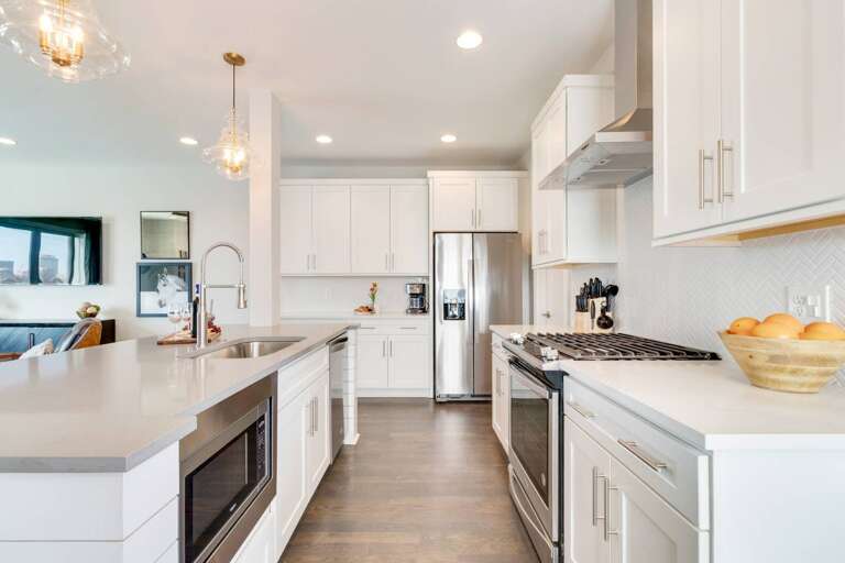 - Fully equipped kitchen with stainless steel appliances, gas stove, &amp; microwave drawer - Crisp white cabinetry, quartz countertops, and pendant lighting elevate the space - Spacious layout perfect for prepping meals, morning coffee, or hosting with e