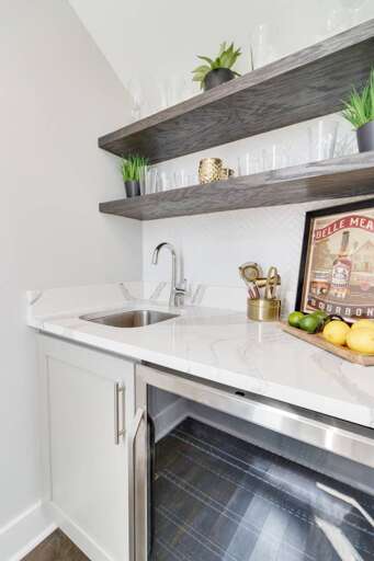 - Marble style countertop with built in stainless steel beverage fridge for your convenience - Compact wet bar area ideal for prepping drinks, snacks, or a quick morning coffee - Modern design with extra storage &amp; a stylish serving board with fresh fr