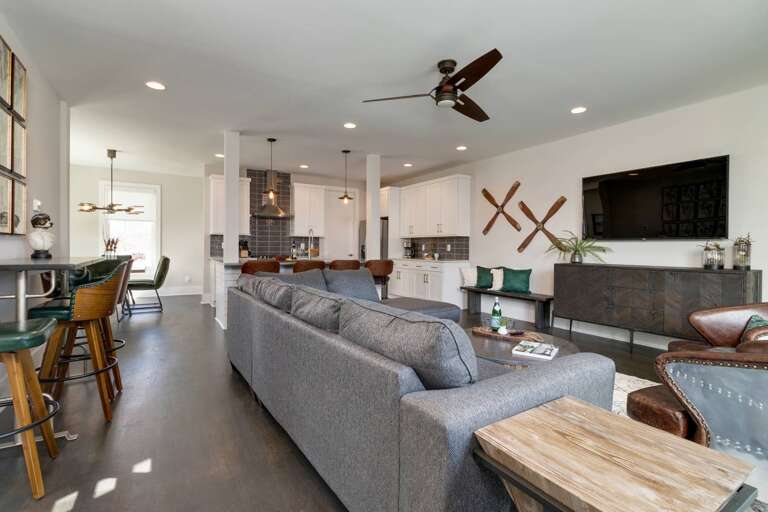 - Gather, unwind, and entertain in this open concept space that brings everyone together - Huge sectional, bar seating, and curated decor make it perfect for group stays - From game night to breakfast at the bar, this setup has room for it all