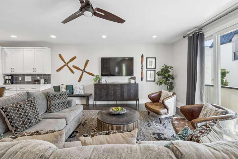 Rich leather club chairs paired with a rustic wood coffee table create an inviting nook - Decorative tray with sparkling water &amp; greenery adds a polished, welcoming touch - Layered textures &amp; industrial modern vibes make this a perfect spot to unw