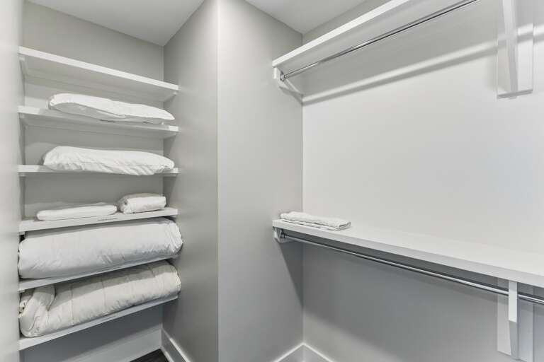 Unpack for real — the walk-in closet has double hanging rods and enough shelf space that your suitcase can stay on the floor.