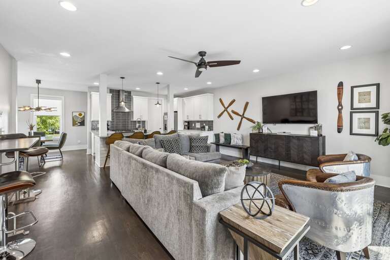 Gather, unwind, and entertain in this open concept space that brings everyone together - Huge sectional, bar seating, and curated decor make it perfect for group stays - From game night to breakfast at the bar, this setup has room for it all
