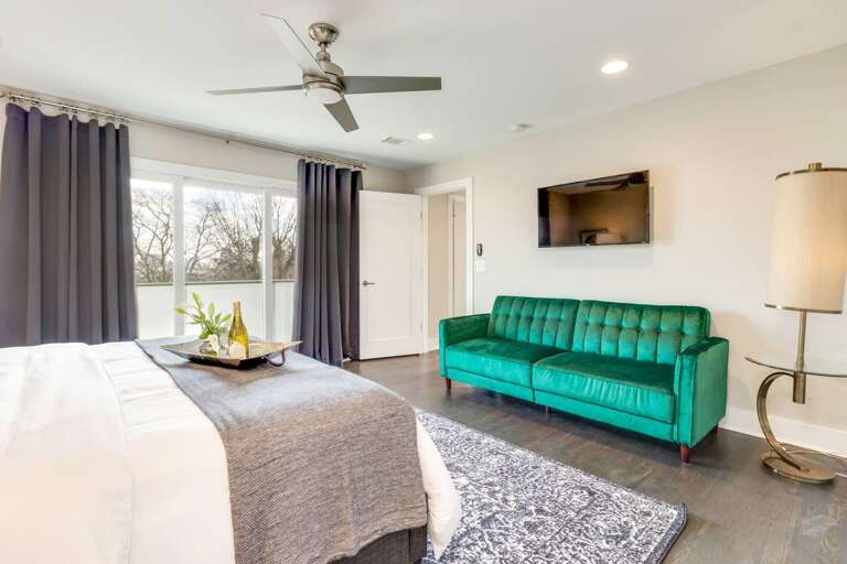- Kick back on the plush emerald green sofa after a day of exploring or lounging - Large windows and blackout curtains let you choose between sunlight or sleep ins - Enjoy your favorite shows on the wall mounted TV without leaving your cozy retreat