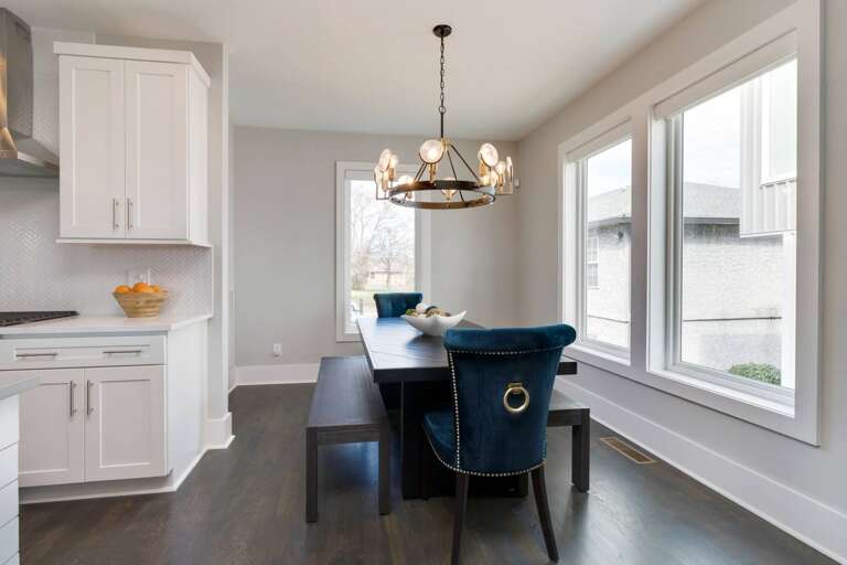 - Stylish dining nook with rich wood table, velvet chairs, &amp; bench seating for a group - Statement chandelier and full length windows brighten up every meal or gathering - Open layout just off the kitchen, perfect for casual breakfasts or dinner parti