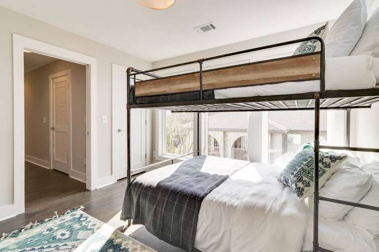 - Natural sunlight pours through wall to wall windows, creating a bright &amp; airy feel - Comfy queen over queen bunk with layered pillows &amp; textured bedding - Inviting layout with warm wood floors, designer rug, &amp; easy hallway access