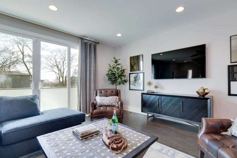 The living area walks out to a balcony overlooking downtown