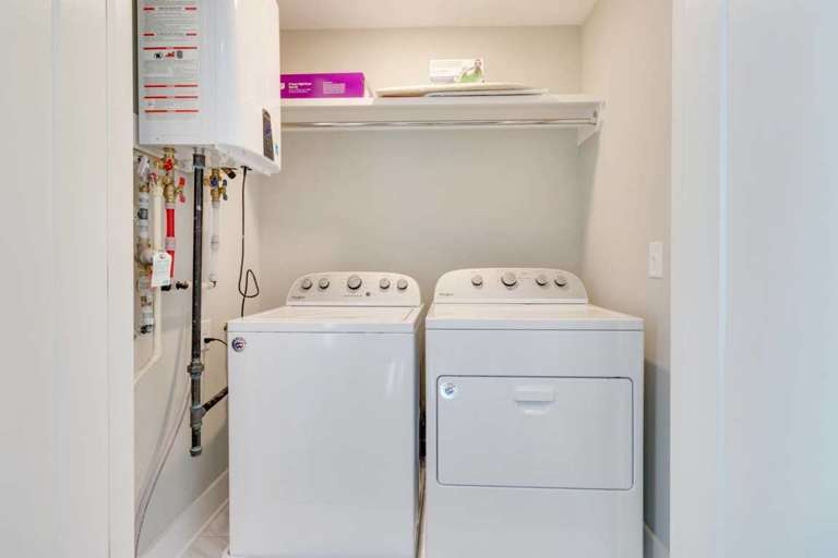 The laundry room is equipped with a washer and dryer