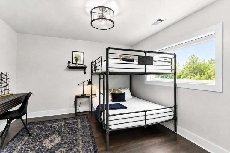 Pick a bunk, open the laptop, and you're done — the second bunk room doubles as a workspace so someone can actually get things done.