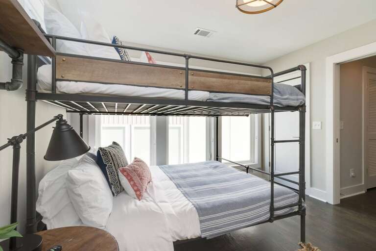 - Clean, modern bedroom perfect for kids or guests with fun bunk bed setup - Stylish and comfortable bedding, accent pillows, and sleek reading light for added appeal - Easy access to hallway and closet ensures convenience during your stay