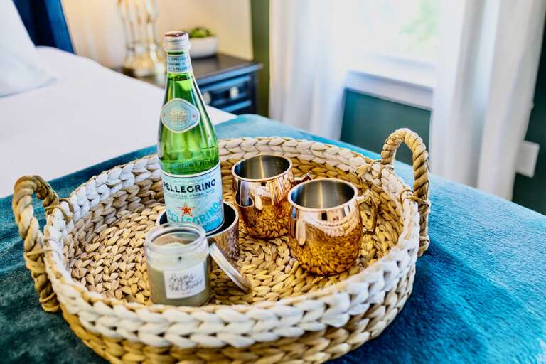- Sip, sparkle, and unwind with a curated tray featuring bubbly, copper mugs, and a cozy candle - It’s the little style that elevate your stay from great to unforgettable - Every detail is designed to make you feel pampered and special  