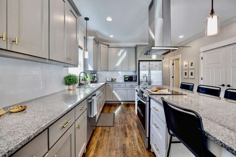 - Pour the wine, cue the music, and cook up memories in this bright, modern kitchen - Granite counters, sleek appliances, and island seating made for good company - Whether it’s pancakes or pasta night, this space brings people together
