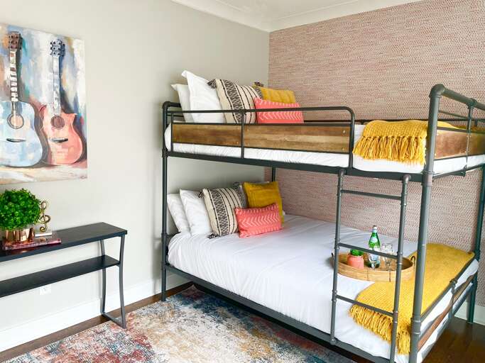 - Welcome to your playful sleep zone, vibrant pillows, cozy throws, and guitar art set the tone - Perfect mix of comfort and character for kids, teens, or the young at heart - Desk space, warm lighting, and Insta worthy vibes included  