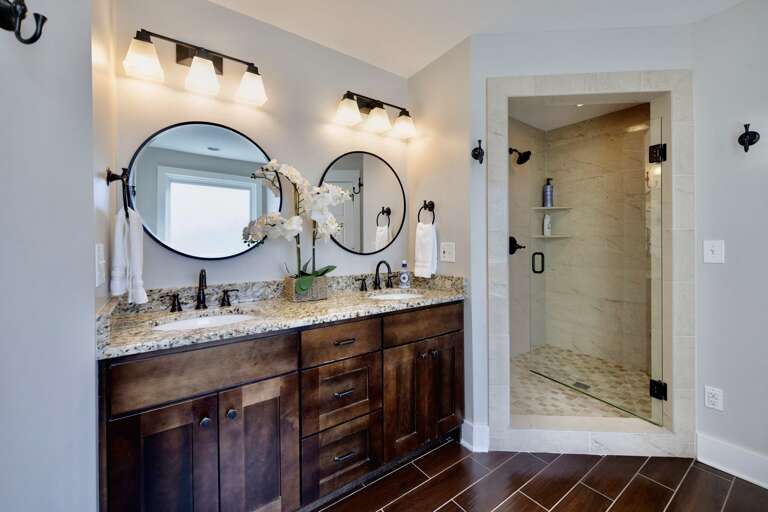 - Treat yourself to a spa like experience with double vanities and designer lighting - Sleek black fixtures and luxe granite counters bring serious style - Step into the glass shower and start your day feeling refreshed and fabulous