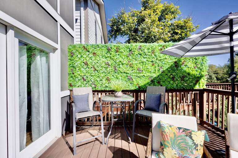 - Step out onto your private balcony with cozy seating, privacy greenery, and vibrant decor - Perfect spot for morning coffee or sunset wine under the umbrella shade - Relax, dine, or simply enjoy the view in stylish comfort