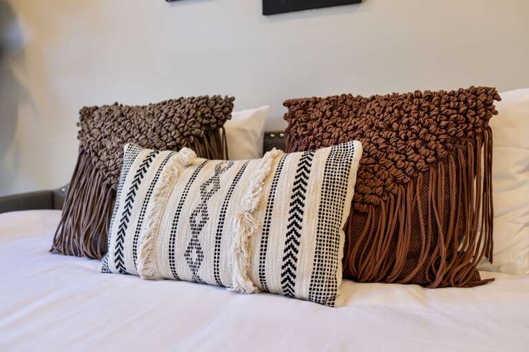 - Cozy up with these textured, boho chic pillows that bring warmth and character to your stay - Earthy tones and fringe details add major style points to the bed - Designed for comfort, crafted for the perfect aesthetic snap