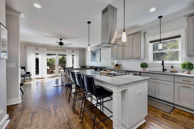 - Bright, open concept kitchen with stylish pendant lighting and modern island seating - Sleek granite countertops, essential appliances, and plenty of prep space for meals - Opens to sunny living area and patio for effortless indoor outdoor flow