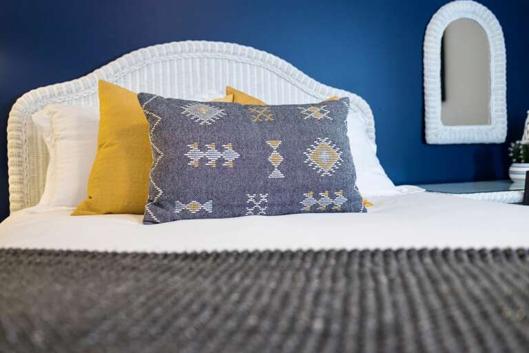 - Dive into this dreamy bed with vibrant pillows and ultra soft sheets calling your name - Bold navy wall sets the scene for cozy nights and lazy mornings - Styled to perfection for snuggling, scrolling, or snoozing in style  