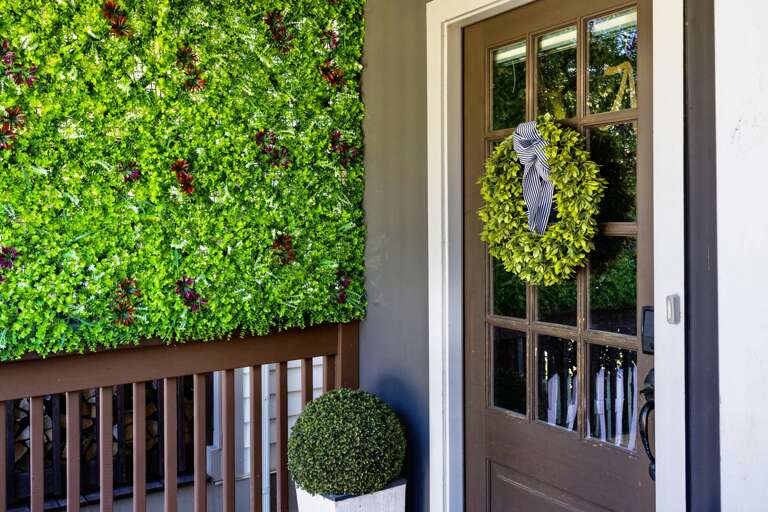Front porch entryway into the house - snag a quick pic in front of our greenery wall on your way in and out!