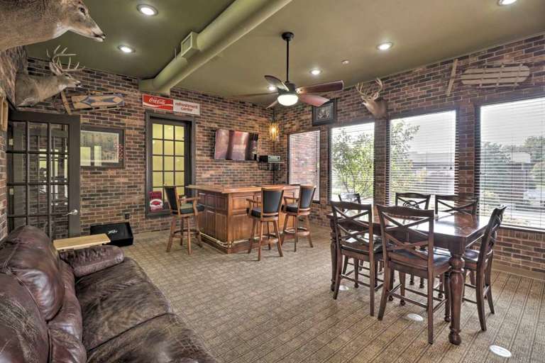 Rustic-style Game Room With Bar And Taxidermy Decor Rustic-style Game Room With Bar And Taxidermy Decor