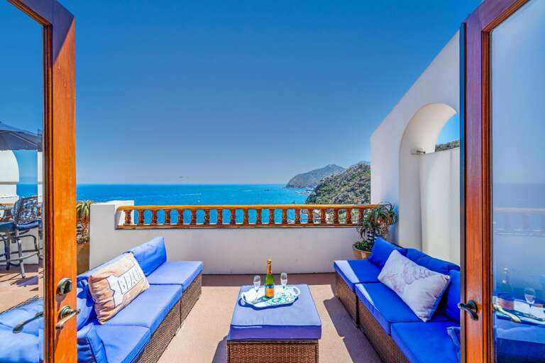 French doors open to the large deck overlooking the pacific and also offers a comfortable outdoor couch.  French doors open to the large deck overlooking the pacific and also offers a comfortable outdoor couch.