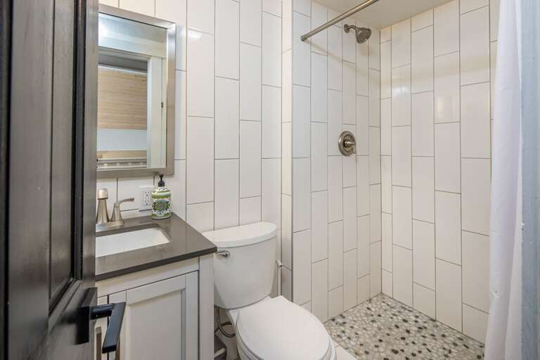 Second Level Mid-size bathroom with a standing shower.