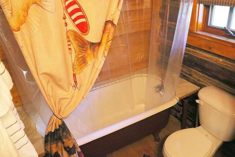 Claw foot tub with shower.