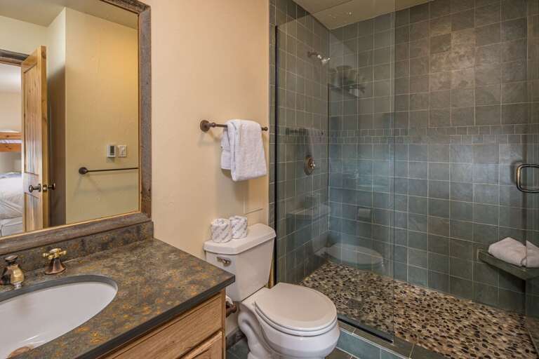 Lower level offers a full-size bathroom with a standing shower