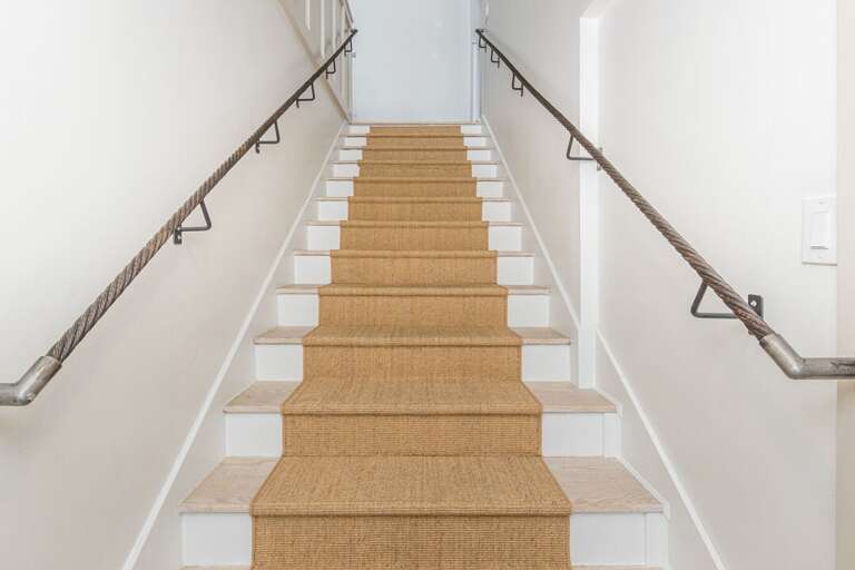 Head down the stairs to another bedroom and the ski room | Lower Level