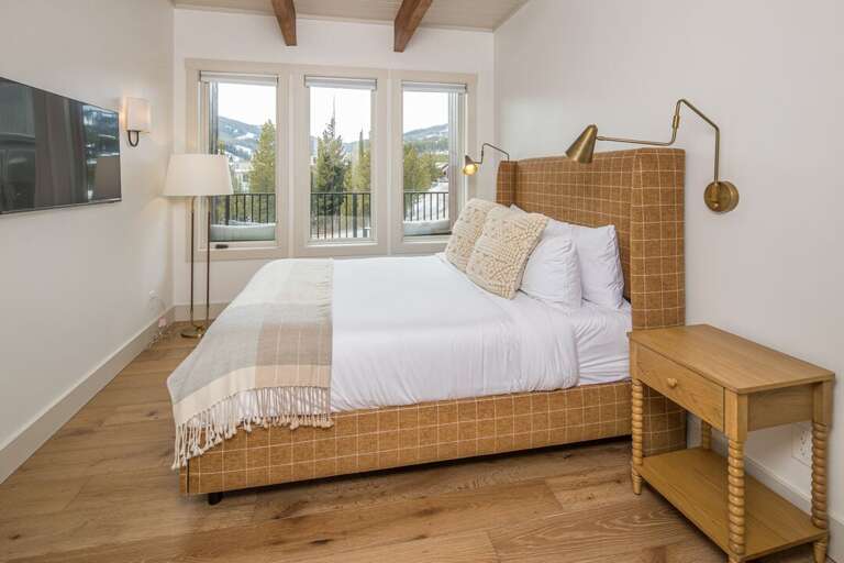 Queen bedroom with smart TV or reading lamps for all comfort styles | Upper Level