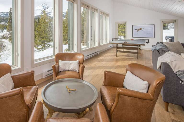 Sit around the coffee table and enjoy the picturesque view of Lone Peak Big Sky | Upper Level