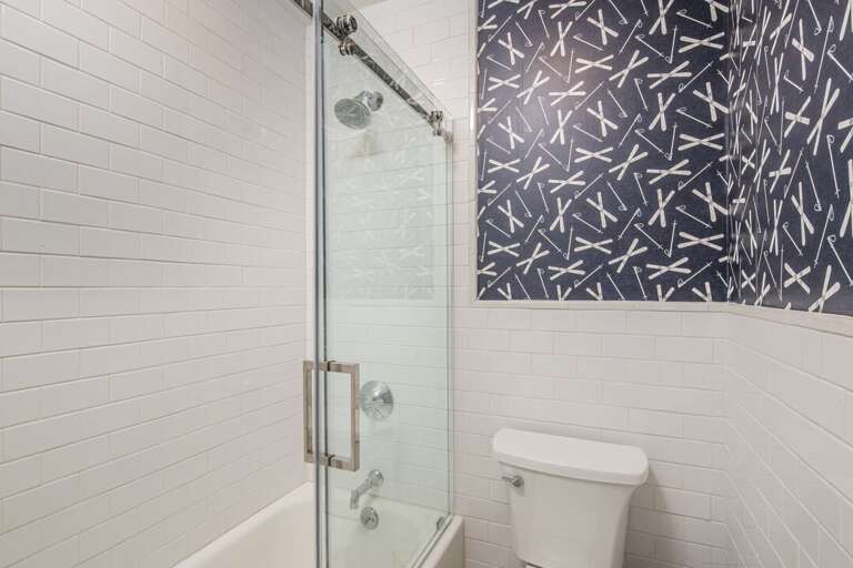 Tub/shower combo in the shared bathroom | Upper Level