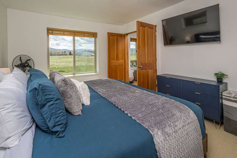Primary Bedroom: King Bed with Views and Media Feature | Main Level Primary Bedroom: King Bed with Views and Media Feature | Main Level