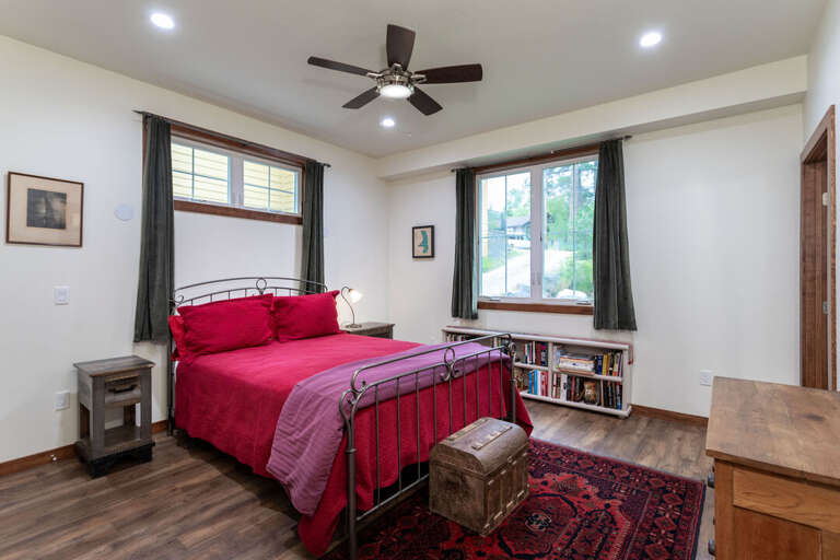 Bedroom 1 is located on the main level with a private ensuite | Queen Bed Bedroom 1 is located on the main level with a private ensuite | Queen Bed