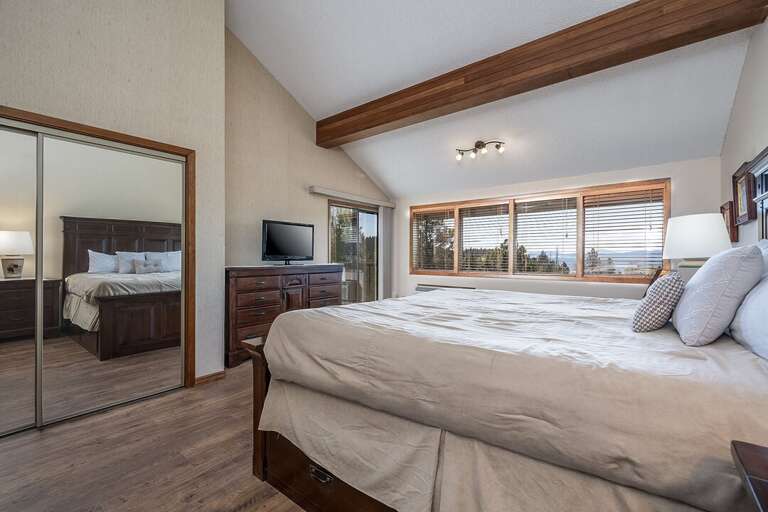 The first bedroom has access to the private balcony | King Bed | Main Level
