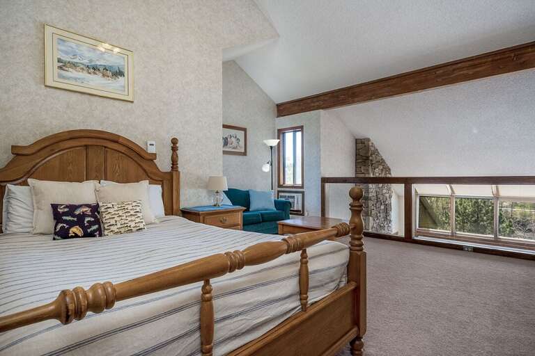 The upper level has a cozy seating area and a comfy Queen bed