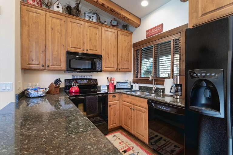 Very nice kitchen with black appliances!
