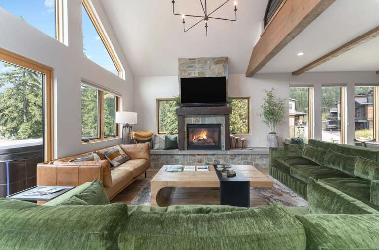 Spacious living room with stone fireplace to get cozy by | Main Level