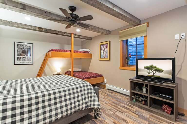 Catch up on a new show before bed | Queen-Sized Bed, Twin-Sized Bunk Beds | Main Level