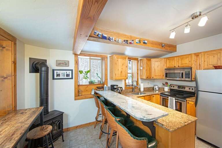 This cozy cabin kitchen is fully equipped with all you need to prepare memorable meals together | Lower Level